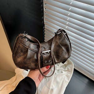 Retro brown crescent shoulder bag with vintage leather texture and silver buckles