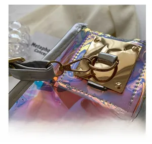 Detail of golden metal hook and silver leather edge on iridescent holographic bag