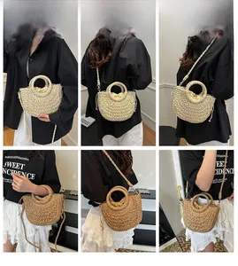 Detail of handmade straw half-moon bag with woven strap and drawstring liner