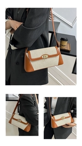 Detail of minimalist beige canvas and brown leather crossbody bag with gold buckle