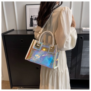 Detailed macro view of laser holographic PVC bag with white leather trim and gold hardware