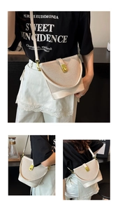 Detail of vintage bucket bag featuring textured beige fabric and gold metal swivel lock