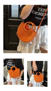 Detail of bright orange handmade straw bag with woven strap and drawstring liner