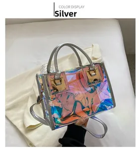 Detail view of holographic PVC mini bag with silver leather handles and gold buckles