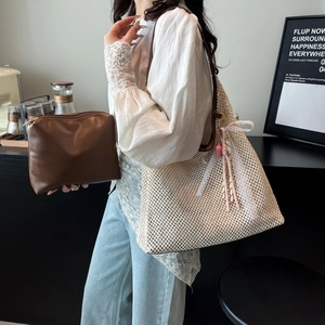 French straw woven tote bag in cream white with brown handles and a lace bow charm