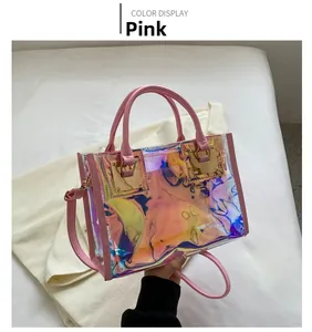 Detailed view of pink iridescent laser PVC small square bag with leather handles