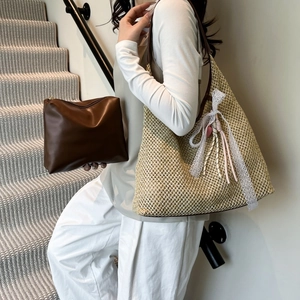 French straw woven bucket bag with leather handles and inner pouch for summer commute