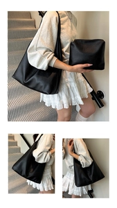 Detail view of black lychee grain leather tote bag set with matching zipper pouch