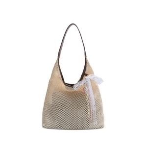 French style straw bucket bag with mesh weave, brown straps, and lace bow decoration