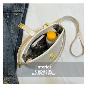 Top view of small bucket bag showing internal capacity with phone and cosmetics