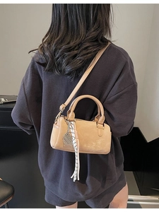 Fashionable khaki Boston bag in matte suede with woven tassel and adjustable strap