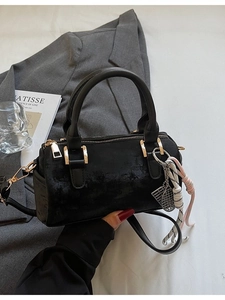 Classic black Boston bag with gold hardware and woven tassel detail for women