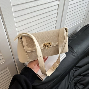 Chic beige baguette underarm bag with gold metal buckle and woven texture detail