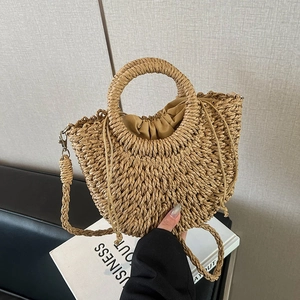 Handmade woven straw handbag with circular handles and drawstring lining for beach use