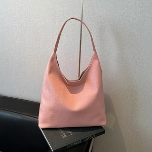 Detail of pink lychee grain leather hobo shoulder bag with textured finish
