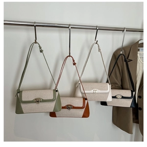 Detailed display of baguette shoulder bags in four colors with canvas and leather patchwork
