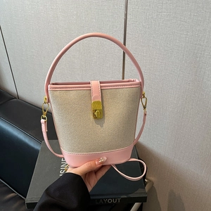 Pink and beige contrast bucket bag with gold metal lock and shoulder strap