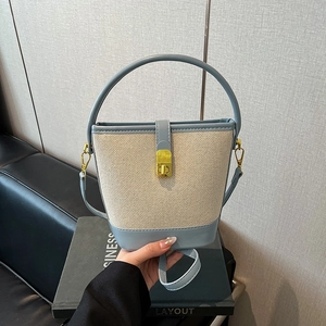 Vintage beige canvas and light blue leather bucket handbag with gold buckle and strap