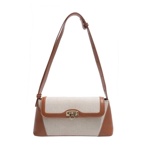 Minimalist canvas and brown leather baguette shoulder bag with golden buckle closure
