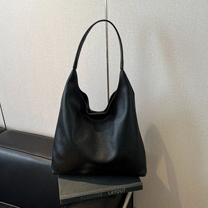Close-up of the black lychee pattern leather texture on a spacious hobo shoulder bag
