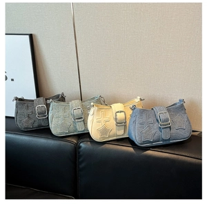 Detailed row of star and cross studded Y2K denim shoulder bags in four vintage colors