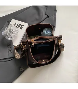 Top view of deep brown bucket bag interior showing spacious capacity and wide strap