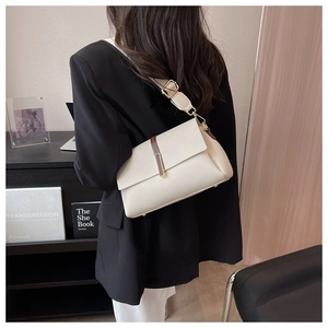 Détail du sac en cuir blanc avec bandoulière marron et boucle en métal doré chic