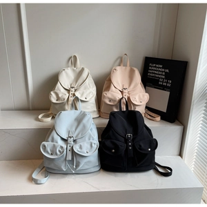 Detail view of stylish college backpacks in four colors with flap closure and metal buckles
