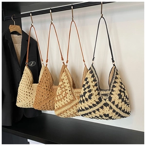Detail view of four crochet woven straw tote bags in various colors for summer vacations