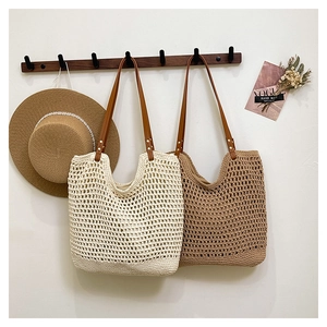 Detail showing woven mesh texture and brown leather straps on straw tote bags