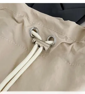 Close-up of durable white drawstring with silver metal cord lock and eyelet detail