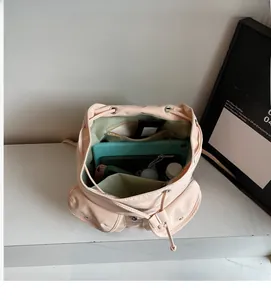 Top view of pink nylon backpack interior showing large capacity for tablets and notebooks