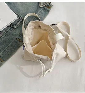 Detail view of large nylon drawstring bucket bag showing internal compartments and storage