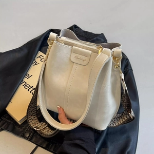 Close-up of a white bucket bag with Ghelikyp logo and geometric jacquard wide strap