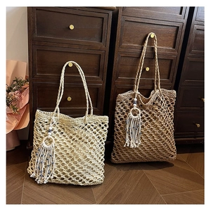 Handmade woven straw tote bags with evil eye charms and tassels in bohemian style