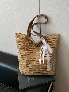 Large capacity woven straw tote bag with brown leather handles and decorative lace accents
