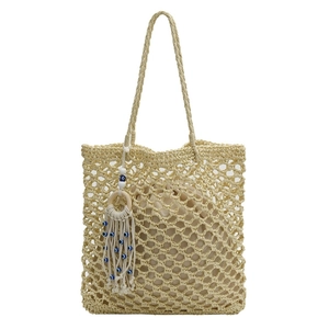 Handwoven straw tote bag with evil eye tassel charm and internal fabric lining