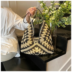 Detailed close-up of the dual-color crochet straw tote bag with geometric floral patterns