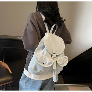 Back view of a trendy light blue nylon backpack with adjustable straps on a model