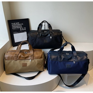 Three premium large travel tote bags in black, khaki, and navy blue with leather handles