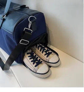 Detail view of the travel bag featuring a side shoe compartment for organized storage
