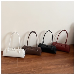Detailed view of long baguette bags in white, dark brown, black, and burgundy leather