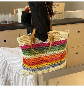 Detail of colorful rainbow striped woven tote bag with premium brown leather handles