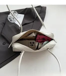 Interior view showing large capacity and zipper pocket of white leather baguette bag