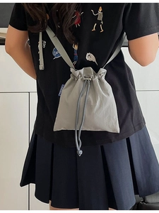 Minimalist grey nylon drawstring crossbody bucket bag for travel and casual daily wear