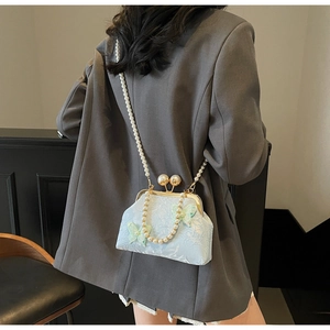 Détail du sac coquillage jacquard bleu clair avec papillons 3D et perles
