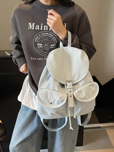 Minimalist light blue backpack for students with flap closure and silver buckle design