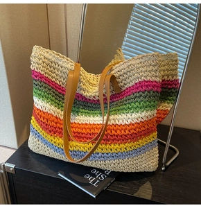 Close-up of the rainbow woven straw texture and premium brown leather handles