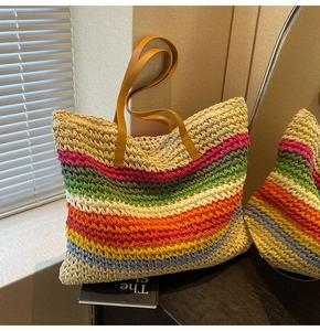Close-up of rainbow striped straw woven tote bag with premium brown leather handles