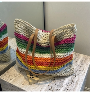 Detail shot of the multi-colored woven straw texture and premium brown leather handles
